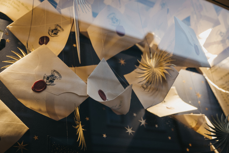 London, UK - December 18, 2018: Harry Potter Hogwarts letters on a retail window display of MinaLima store in Covent Garden, a famous tourist area in London with lots of shops and restaurants.のeditorial素材
