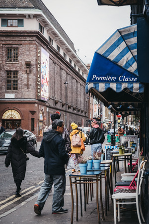 London, UK - December 18, 2018: People walking past restaurants in Covent Garden, London, UK. Covent Garden is a famous tourist area in London with lots of shops and restaurants.のeditorial素材