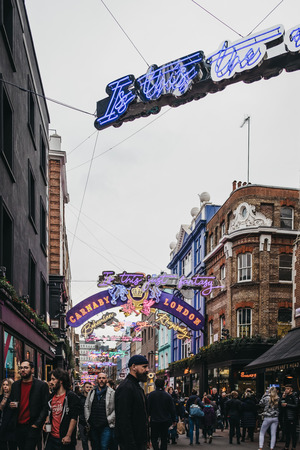 London, UK - December 19, 2018: People walking under Bohemian Rhapsody themed Christmas lights in Carnaby Street, pedestrianised shopping street in Soho with over 100 shops and restaurants.のeditorial素材