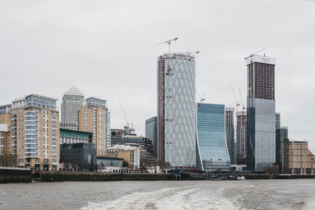 London, UK - March 16, 2019: View of Canary Wharf skyscrapers from River Thames. Canary Wharf is a busy financial area of London, UK.のeditorial素材