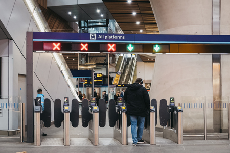 London, UK - March 16, 2019: Man using his travel card on the entrance gates inside London bridge...