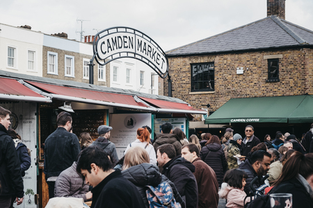 London, UK - March 23, 2019: People sitting at outdoor tables inside Camden Market, London. Started with 16 stalls in March 1974, Camden Market is one of the busiest retail destinations in London.のeditorial素材