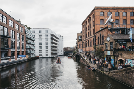 London, UK - March 23, 2019:  Tour boat passing Camden Market on Regent's Canal, London. In 2020 the Regentâs Canal will be 200 years old.のeditorial素材