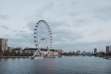 London, UK - April 13, 2019: View of London Eye, city skyline and landmarks from Millennium Bridge. London is one of the most visited cities in the world.のeditorial素材