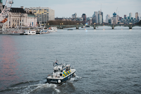London, UK - April 13, 2019: Metropolitan Police Marine Policing Unit (MPU) on the River Thames, London on the background. MPU fleet is responsible for policing the River Thames within Greater Londonのeditorial素材