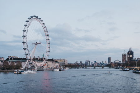London, UK - April 13, 2019: View of London Eye, city skyline and landmarks from Millennium Bridge. London is one of the most visited cities in the world.のeditorial素材