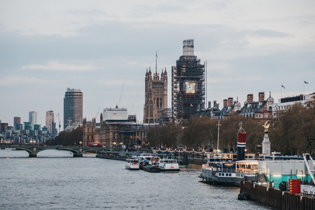 London, UK - April 13, 2019: View of London skyline and Big Ben in scaffolding from Millennium Bridge. London is one of the most visited cities in the world.のeditorial素材