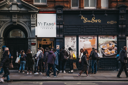 London, UK - April 13, 2019: People queuing to buy Taiwan fruit tea from Yi Fang shop in Chinatown, London. Chinatown is home to an East Asian community and is famous for its eateries and events.のeditorial素材