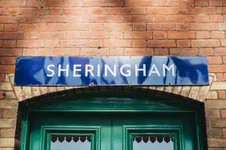 Sheringham, UK - April 21, 2019: Retro Sheringham station name on a wall at a train station in Sheringham, a popular English seaside town within the county of Norfolk, UK.のeditorial素材