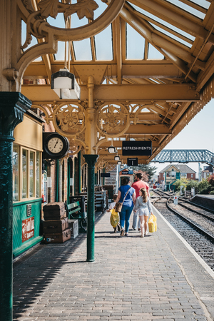 Sheringham, UK - April 21, 2019: Family walking on a train platform of Sheringham train station on a sunny spring day. Sheringham is an English seaside town within the county of Norfolk, UK.のeditorial素材