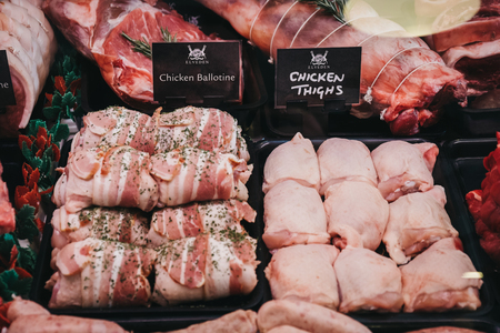 Elveden, UK - April 21, 2019: Variety of meats and meat products on sale inside The Courtyard, a country mall that sells gifts and locally produced food, and located just off A11 in Elveden, UK.のeditorial素材