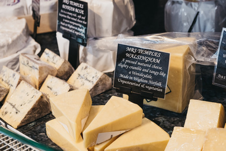 Elveden, UK - April 21, 2019: Variety of cheeses on sale inside The Courtyard, a country mall that sells gifts and locally produced food, and located just off A11 in Elveden, UK.のeditorial素材