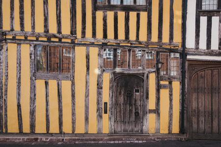 Facade of half-timbered colourful medieval houses, located in the village of Lavenham, Suffolk, England, UK.の写真素材