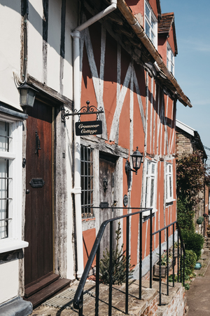 Lavenham, UK - April 19, 2019: Facade of a house in Lavenham, a village in Suffolk, England, famous for its Guildhall, Little Hall and half-timbered colourful medieval cottages.のeditorial素材