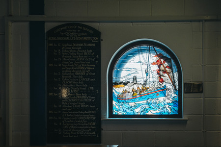 Cromer, UK - April 20, 2019: Stained glass window on RNLI Lifeboat station in Cromer. Cromer is a seaside town in Norfolk and a popular family holiday destination in UK.のeditorial素材