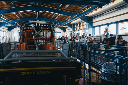 Cromer, UK - April 20, 2019: People inside RNLI Lifeboat station in Cromer. Cromer is a seaside town in Norfolk and a popular family holiday destination in UK.のeditorial素材