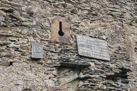 Vianden, Luxembourg - May 18, 2019: Signs on a wall of Vianden Castle, Luxembourg, one of the largest and finest feudal residences of the Roman and Gothic eras in Europe.のeditorial素材