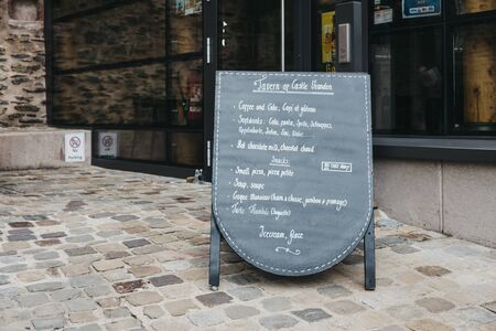 Vianden, Luxembourg - May 18, 2019: Black board menu outside of a Tavern within Vianden Castle, Luxembourg, one of the largest and finest feudal residences of the Roman and Gothic eras in Europe.のeditorial素材