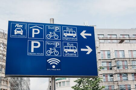 Luxembourg City, Luxembourg - May 18, 2019: Directional sign to facilities, buses and parking outside of Gare de Luxembourg, the main railway station serving the city.のeditorial素材