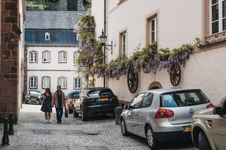 Vianden, Luxembourg - May 18, 2019: Middle-aged couple walking on a street in Vianden, a town in Luxembourgâs Ardennes region known for the centuries-old hilltop Vianden Castle.のeditorial素材