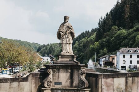 Vianden, Luxembourg - May 18, 2019: Statue of Saint John of Nepomuk on a bridge over the river Our in Vianden, a town in Luxembourgs Ardennes region known for the centuries-old hilltop Vianden Castle.のeditorial素材