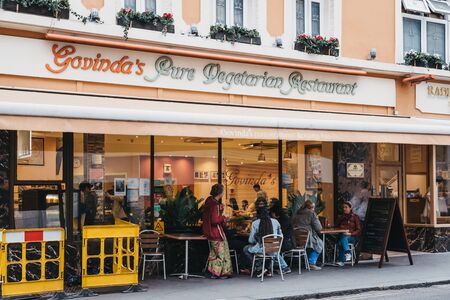 London, UK - June 5, 2019: People sitting at the outdoor tables of Govinda's Pure Vegetarian Restaurant, one of London's oldest vegetarian eateries.のeditorial素材