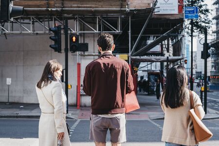 London, UK - June 15, 2019: Rear view of people waiting to cross the street in the City of London, Londons famous financial district. Dのeditorial素材