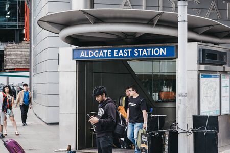 London, UK - June 22, 2019: People walking out of Aldgate East, an Underground station on...