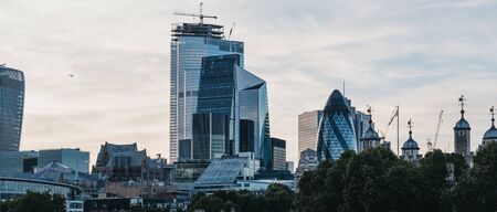 London, UK - June 22, 2019: Panoramic view of skyscrapers and modern office buildings of the City of London, London's famous financial district, from the other side of River Thames during blue hour.のeditorial素材