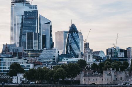 London, UK - June 22, 2019: Skyscrapers and modern office buildings of the City of London, London's famous financial district, from the other side of River Thames during blue hour.のeditorial素材