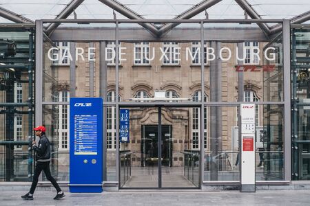 Luxembourg City, Luxembourg - May 19, 2019: Man walking past the entrance of Gare de Luxembourg, the...