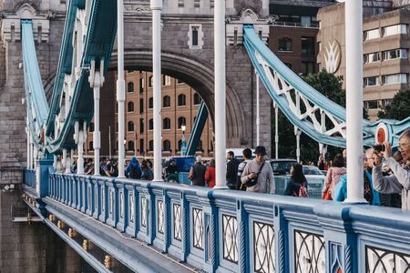 London, UK - June 22, 2019: People walking on Tower Bridge, London, at dusk. Tower bridge is a famous bridge and international landmark often mistakes for London Bridge.のeditorial素材