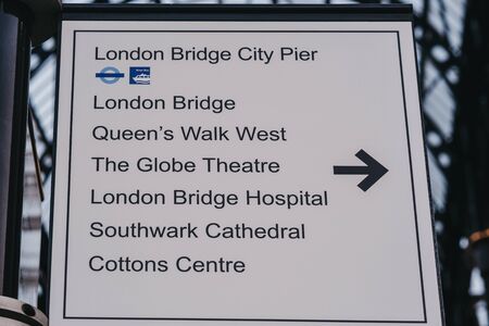 London, UK - June 22, 2019: Directional signs inside Hays Galleria by London Bridge City Pier at dusk, selective focus. The pier serves as the main pier for the City of London and City Hall.のeditorial素材