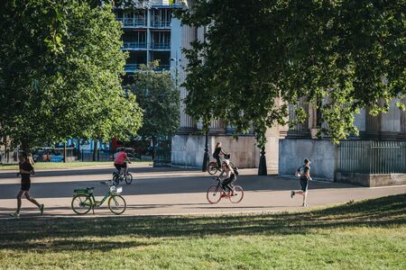 London, UK - July 15, 2019: People cycling and running in London in summer. Cycling is a popular way of getting around the city.のeditorial素材