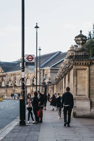 London, UK - July 15, 2019: People walking past and standing at the bus stop near Buckingham Palace, the London residence and administrative headquarters of the monarch of the United Kingdom.のeditorial素材