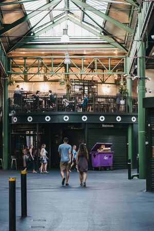 London, UK - July 23, 2019: People walking inside Borough Market, one of the largest and oldest food...