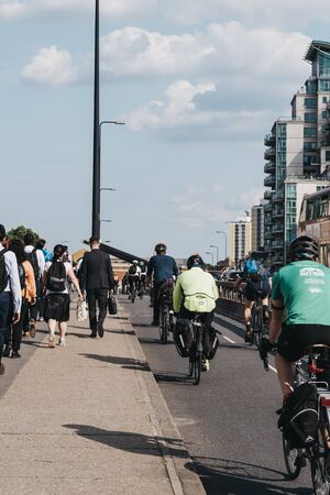 London, UK - July 16, 2019: Pedestrian and cyclists on Vauxhall Bridge in London, during rush hour, selective focus. Cycling is a popular way of getting around the city.のeditorial素材