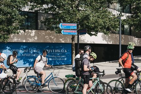 London, UK - July 16, 2019: Group of cyclists waiting on a traffic light on street in Pimlico, London, selective focus. Cycling is a popular way of getting around the city.のeditorial素材