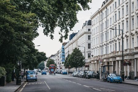 London, UK - July 16, 2019: Row of white terraced houses on a street in Pimlico, an upscale residential area of London with quiet streets lined with stately homes.のeditorial素材