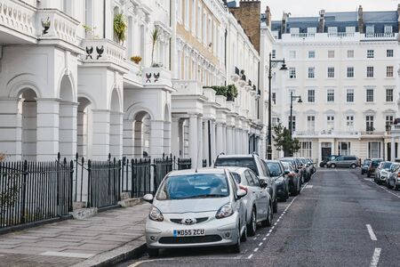 London, UK - July 16, 2019: Cars parked outside white terraced houses on a street in Pimlico, an...