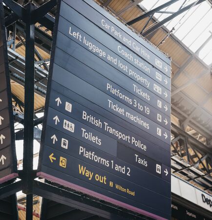 London, UK - July 16, 2019: Low angle view of the directional sign inside Victoria train station,...