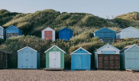 Milford on Sea, UK - July 13, 2019: Rows of colorful beach huts in Milford on Sea, a traditional English village famous for breathtaking cliff top walks with spectacular views and great pebble beachesのeditorial素材