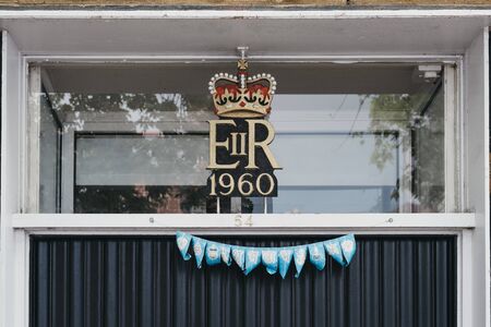 Lymington, UK - July 14, 2019:1960 Royal cypher of HM the Queen Elizabeth II (EIIR) on a building in...