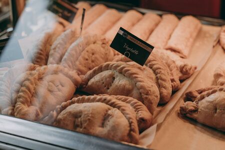 Lymington, UK - July 14, 2019: Cornish pasties on sale at a Mines A Pasty shop in Lymington, UK. Cornish pasty is a traditional British food particularly associated with Cornwall and Devon.のeditorial素材