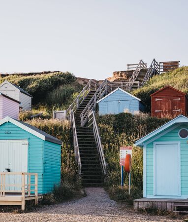 Milford on Sea, UK - July 13, 2019: Stairs to the beach between colourful beach huts in Milford on Sea, a traditional English village famous for breathtaking cliff top walks and great pebble beachesのeditorial素材