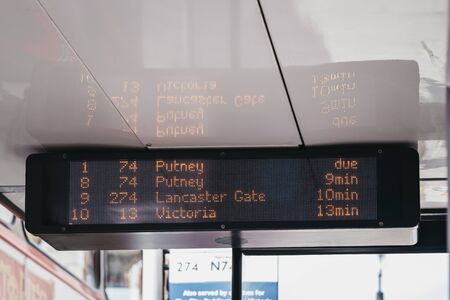 Close up of a upcoming buses schedule on digital screen on a bus stop in London, UK.の写真素材