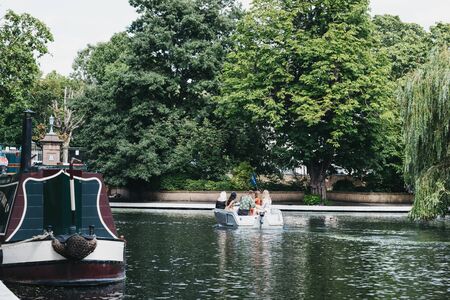 London, UK - July 18, 2019: People having a picnic on a boat on Regents Canal in Little Venice, London, a tranquil area of the city where the Grand Union and Regentâs canals meet.のeditorial素材