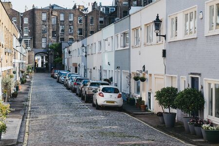 London, UK - July 18, 2019: Cars parked outside mews houses in Paddington, London. Houses in mews are one of the most luxurious and desirable in Londonのeditorial素材