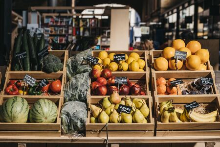 London, UK - September 07, 2019: Fresh fruits in wooden crates on sale at Spitalfields Market, one of the finest surviving Victorian Market Halls in London with fashion, antiques and food stalls.のeditorial素材