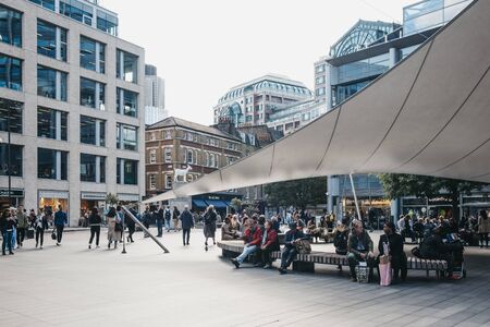 London, UK - September 7, 2019: People walking and relaxing outside Spitalfields Market, one of the finest Market Halls in London with stalls offering fashion, antiques and food. Selective focus.のeditorial素材
